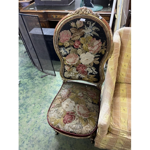 489 - Antique gold painted shield back nursing chair, upholstered in floral needlepoint, raised on French ... 