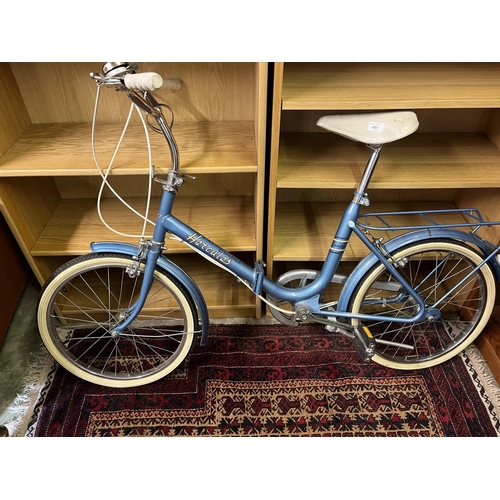 497 - Hercules compact blue bike.