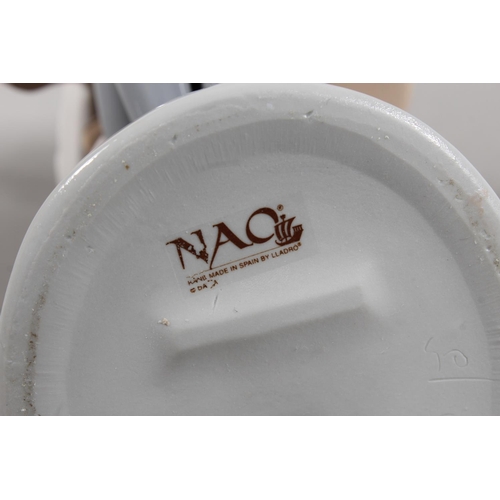 267 - Nao figure of a girl artist with easel, 34cm tall.