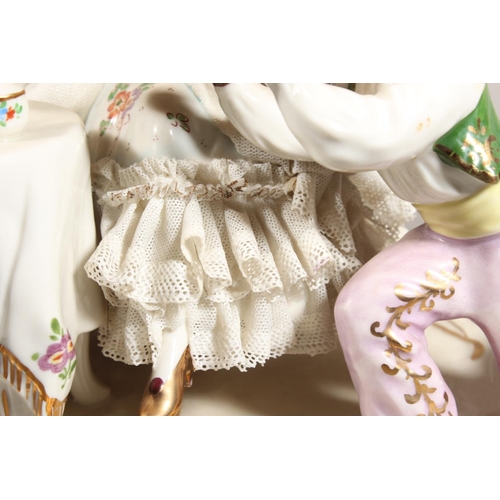 10C - Dresden of Germany figure group depicting a Victorian tea scene.