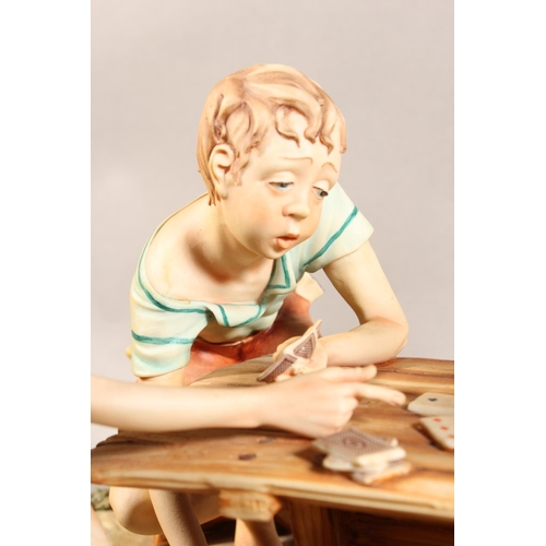 10D - Capo di monte figure group 'The Cheat', signed to base.