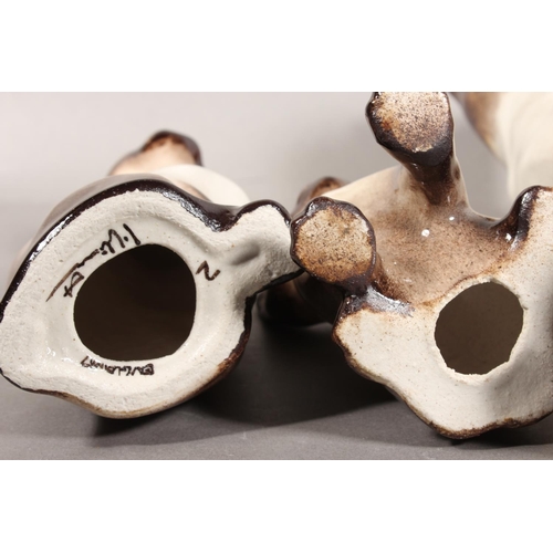 14 - Three Winstanley pottery Siamese cats with blue eyes, largest 31cm high.