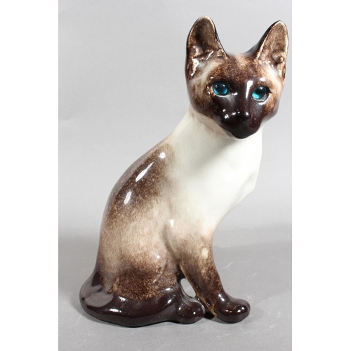 15 - Four Winstanley pottery Siamese cats with blue eyes, largest 26cm high.