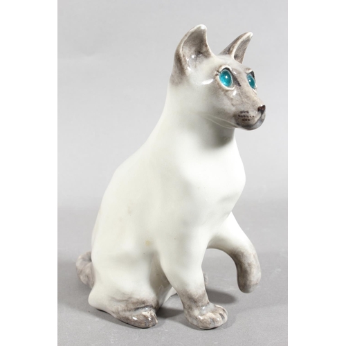 17 - Winstanley pottery Siamese cat with blue eyes, 20cm high.