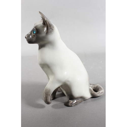 17 - Winstanley pottery Siamese cat with blue eyes, 20cm high.