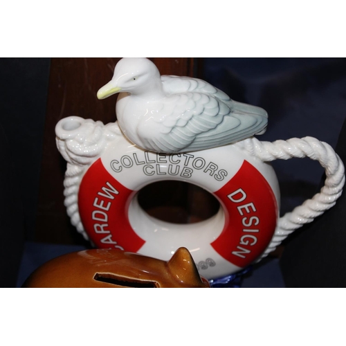 58 - Decorative ceramics to include Hummel figures, a Wade Andy Capp money box, a Cardew Collectors Club ... 