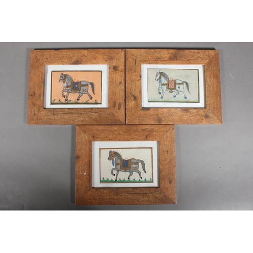 68 - Three Mughal Indian style silk pictures of royal horses, in wooden frames.