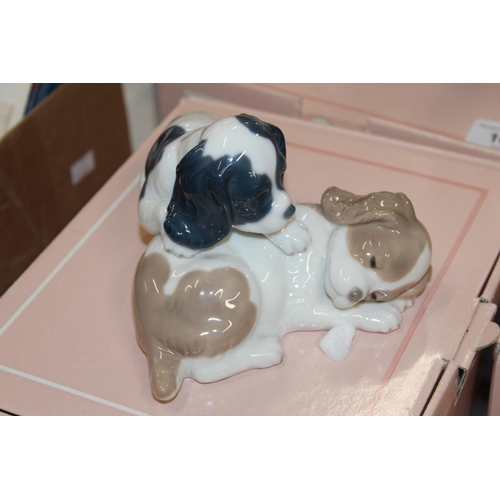 106 - Five Nao figures, boxed, to include a clown, a dog group, etc.