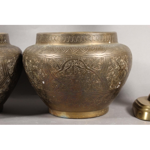 84 - Two pairs of brass candlesticks and a pair of Eastern decorated brass pots.