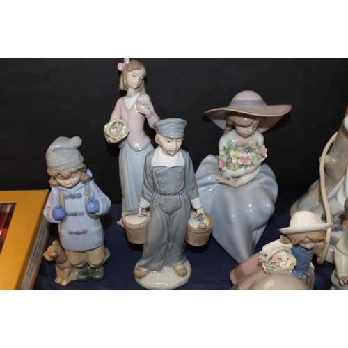 97 - Lladro, and other, figure groups to include cats, flowers, etc., and a table lamp.