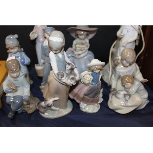 97 - Lladro, and other, figure groups to include cats, flowers, etc., and a table lamp.