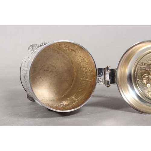 172 - Danish white metal lidded stein decorated in repousse with musicians, 14cm high.