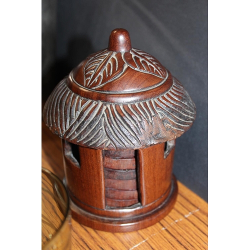 184 - Carved hardwood set of six coasters held in hut shaped box and a set of green glass brandy glasses w... 