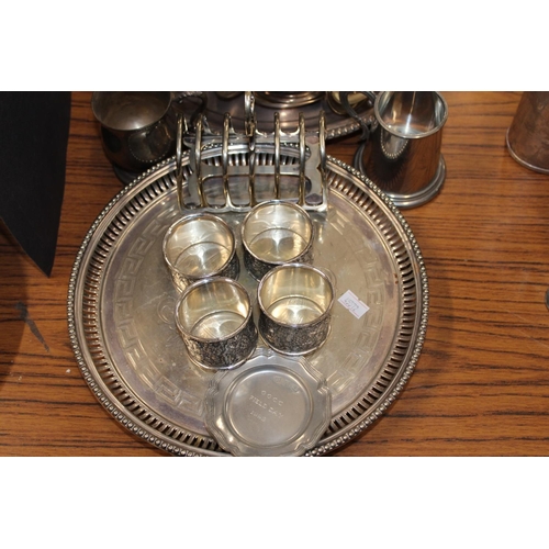 186 - Silver-plated ware to include napkin rings, a toast rack, flatware, an ice bucket, a rose bowl, etc.