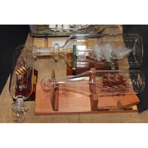 204 - Ships in bottles to include a model of a four-masted Barquentine by A Wilson, 1973, a Santa Maria, e... 
