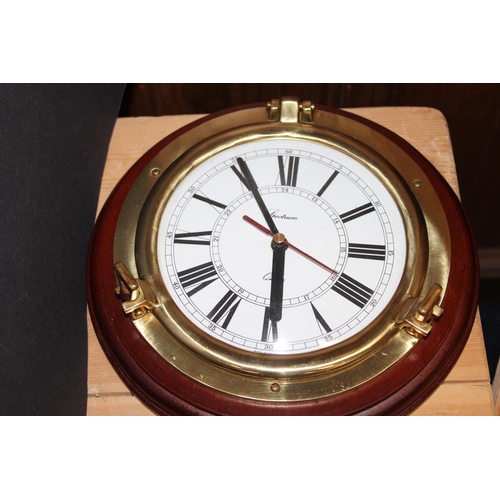 221 - Two ships porthole wall clocks by Spectrum and a similar wall barometer, 24cm diameter.