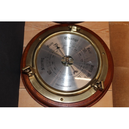 221 - Two ships porthole wall clocks by Spectrum and a similar wall barometer, 24cm diameter.
