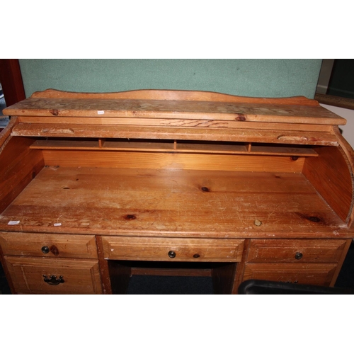562 - Pine roll top desk.