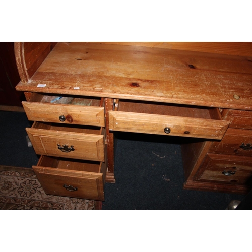 562 - Pine roll top desk.