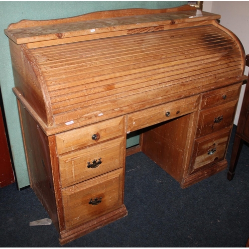 562 - Pine roll top desk.