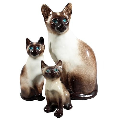 Three Winstanley pottery Siamese cats with blue eyes, largest 31cm high.