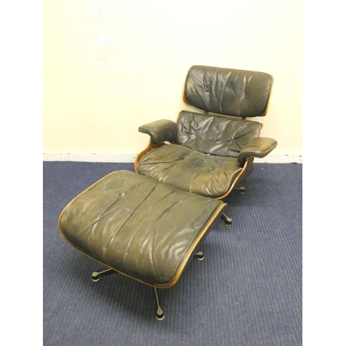 409 - Charles and Ray Eames chair and a footstool upholstered in black leather.