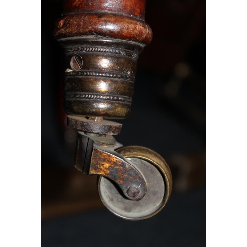 545 - Antique mahogany armchair, raised on fluted supports with brass castors.