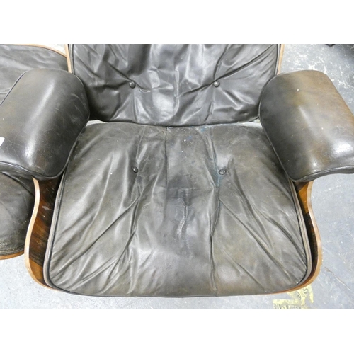 409 - Charles and Ray Eames chair and a footstool upholstered in black leather.