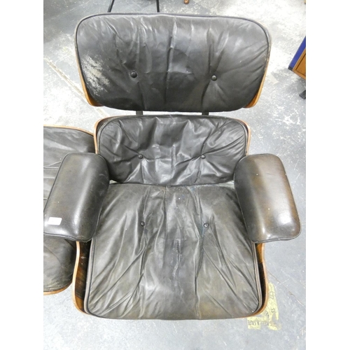 409 - Charles and Ray Eames chair and a footstool upholstered in black leather.