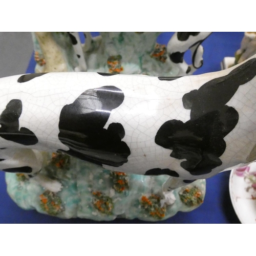 84 - Pair of Victorian Staffordshire pottery black and white Disraeli greyhound figures, one with a hare ... 