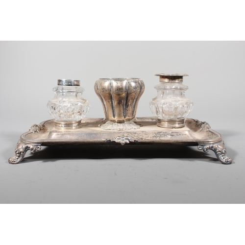 25 - William IV silver desk stand with twin glass inkwells raised on scrolling feet, Charles Reily & ... 