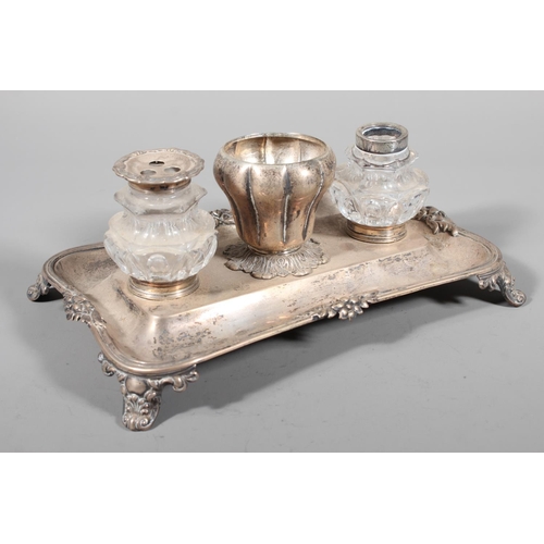 25 - William IV silver desk stand with twin glass inkwells raised on scrolling feet, Charles Reily & ... 