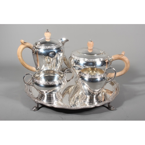 27 - Four piece silver tea service on matching tray, with Lindisfarne border decoration and stamp to base... 