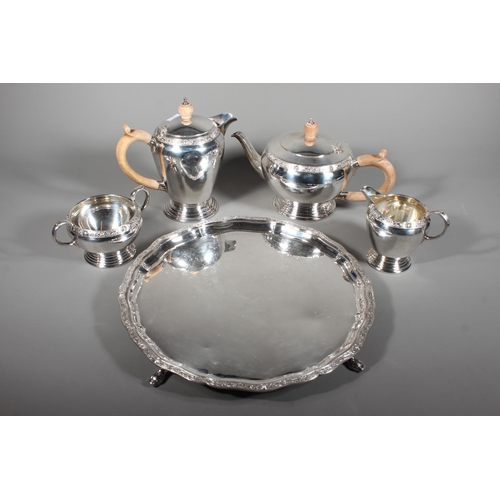 27 - Four piece silver tea service on matching tray, with Lindisfarne border decoration and stamp to base... 