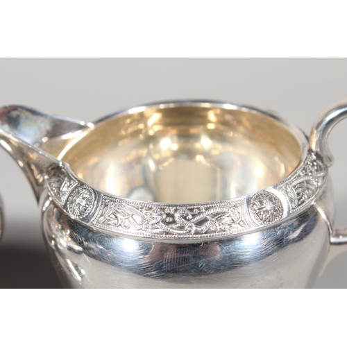 27 - Four piece silver tea service on matching tray, with Lindisfarne border decoration and stamp to base... 