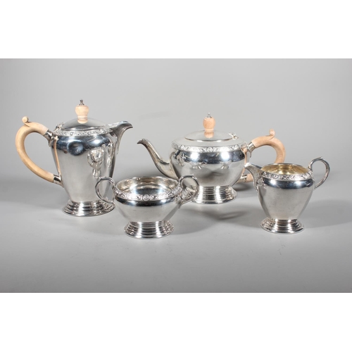 27 - Four piece silver tea service on matching tray, with Lindisfarne border decoration and stamp to base... 