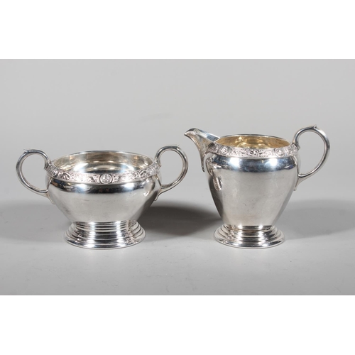 27 - Four piece silver tea service on matching tray, with Lindisfarne border decoration and stamp to base... 