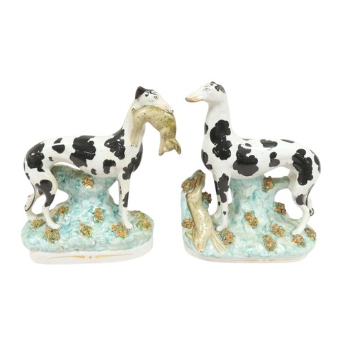 84 - Pair of Victorian Staffordshire pottery black and white Disraeli greyhound figures, one with a hare ... 