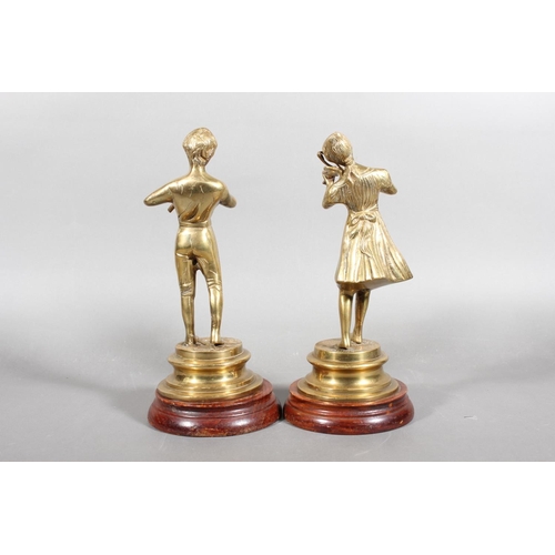 100 - Pair of brass musical figures on hardwood stands.