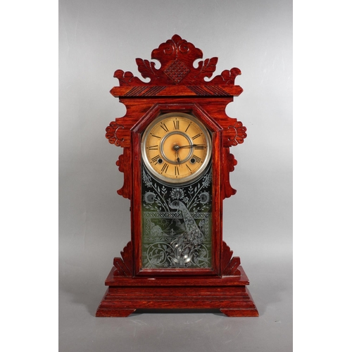 102 - Ansonia clock with Roman numeral chapter ring and carved wood case.