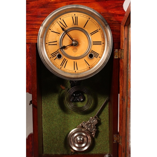 102 - Ansonia clock with Roman numeral chapter ring and carved wood case.
