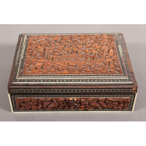 105 - Heavily carved wooden box with inlay.