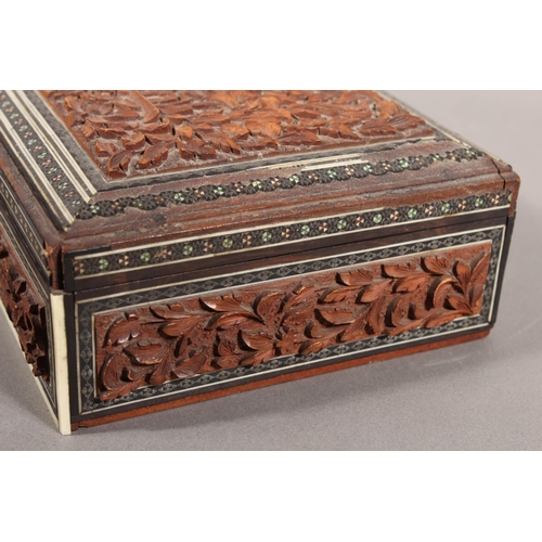 105 - Heavily carved wooden box with inlay.