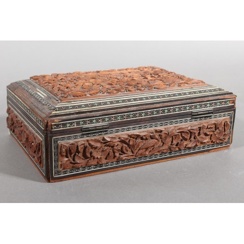105 - Heavily carved wooden box with inlay.