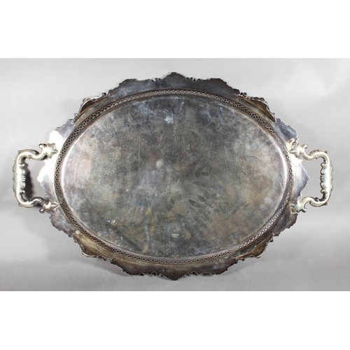 12 - Silver-plated twin-handled scroll and foliate decorated tray with pierced gallery....
