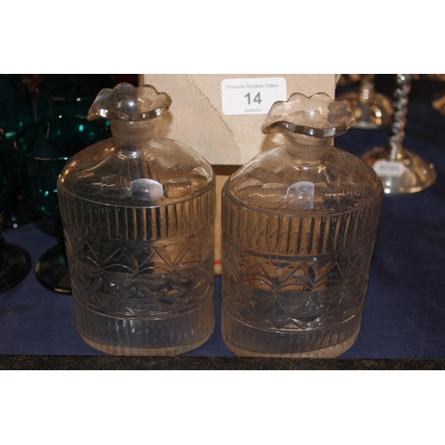 14 - Glass stoppers, a pair of cut-glass decanters and four green glass drinking glasses....
