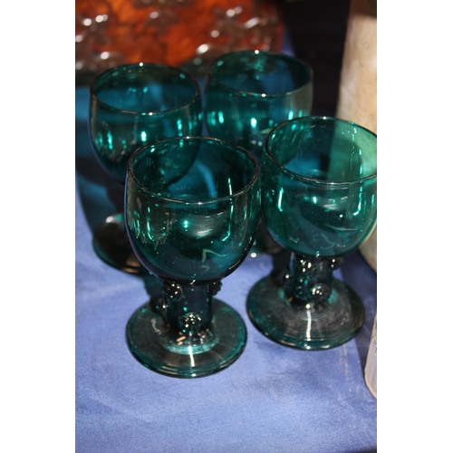 14 - Glass stoppers, a pair of cut-glass decanters and four green glass drinking glasses....