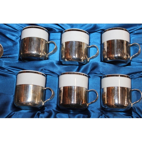 31 - Cased set of six coffee cans and teaspoons, with matching saucers in white metal casings....