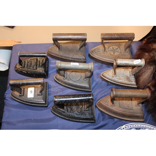 61 - Eight antique flat irons to include Siddens, Falkirk, Salter, etc.