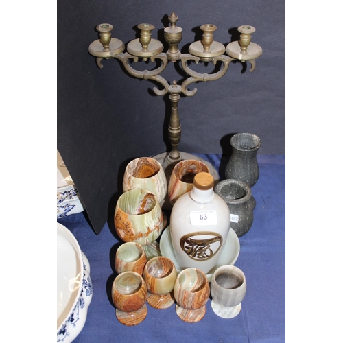 63 - Onyx goblets, a brass candlestick, a pottery bottle.